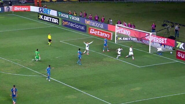 Goleiro defendendo no campo de futebol.