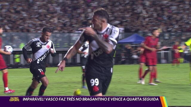Vasco jogando no estádio com jogadores e torcida ao fundo.