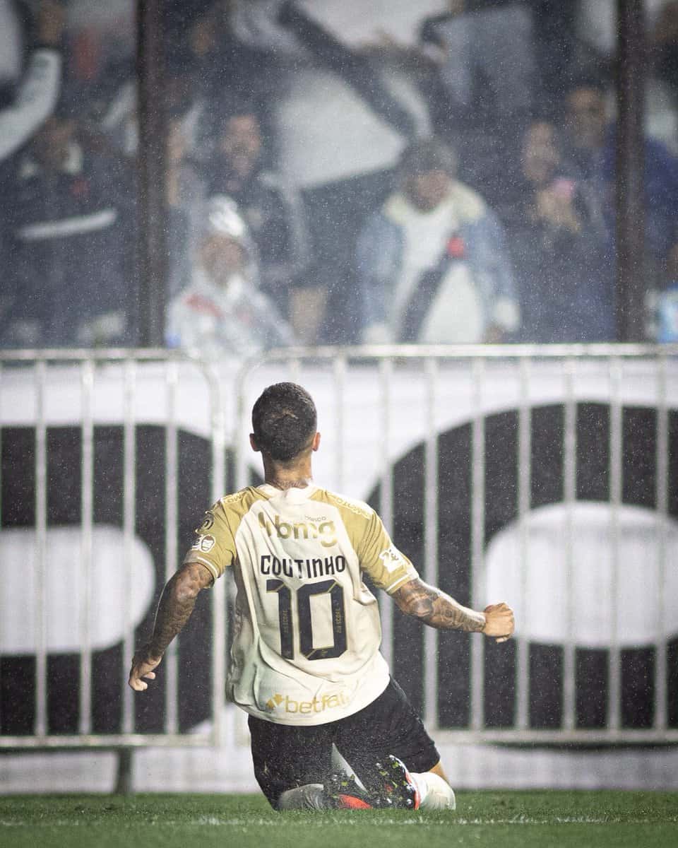 Goleiro do Vasco comemorando gol em campo molhado.