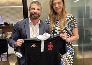 Camiseta do Vasco sendo segurada por duas pessoas.