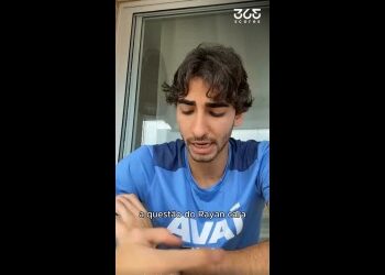 Homem com cabelo cacheado usando camisa azul.