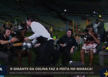 Policeman serving drinks at a celebration.
