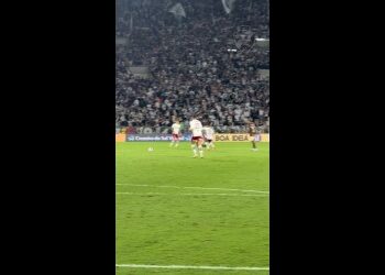 Jogadores em campo durante partida de futebol.