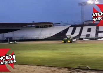 Estádio do Vasco iluminado à noite com publicidade.