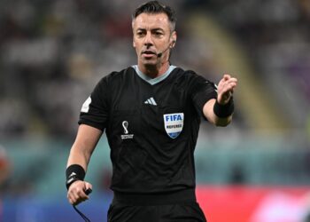 Árbitro de futebol em ação no campo.