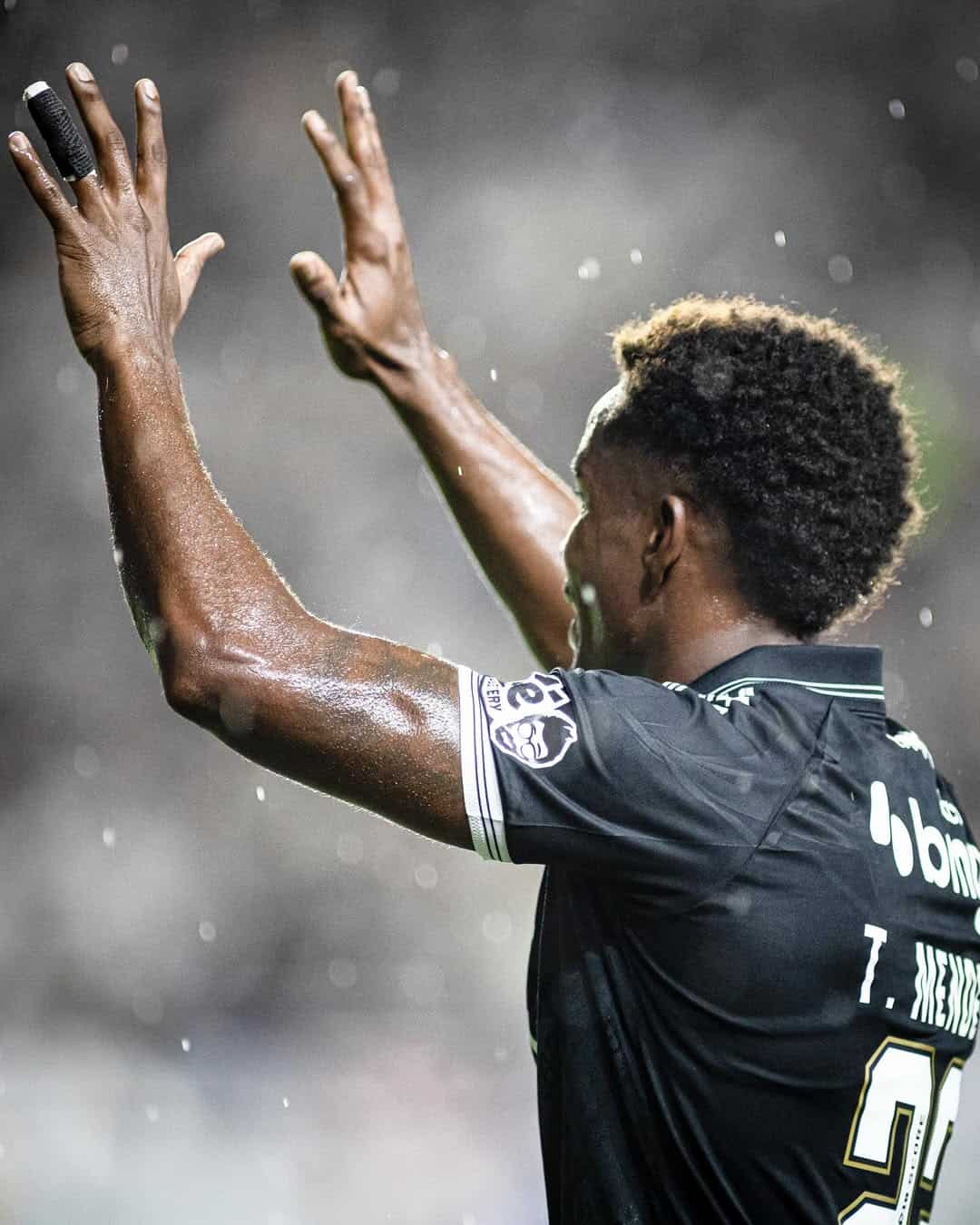 Jogador do Vasco em ação, celebrando uma jogada, com destaque para o uniforme do time.