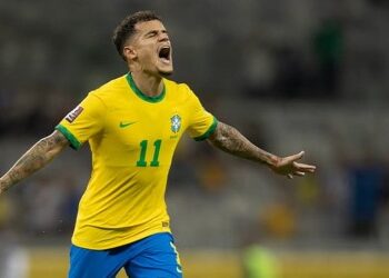 Bandeirinha comemorando gol da seleção brasileira.
