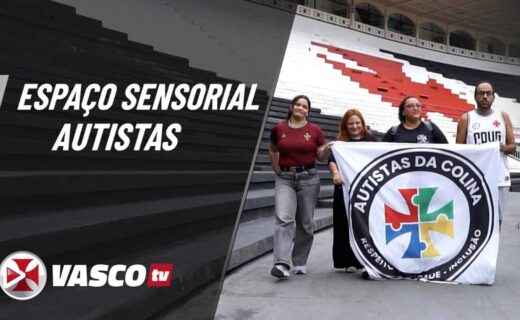 Pessoas segurando bandeira de autistas na noite do estádio.